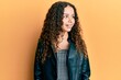 © Krakenimages.com - Teenager hispanic girl wearing black leather jacket looking away to side with smile on face, natural expression. laughing confident.