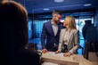 © dusanpetkovic1 - A middle-aged couple on a honeymoon checking in a hotel.