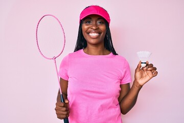 Canvas Print - African american woman with braids holding badminton racket smiling with a happy and cool smile on face. showing teeth.