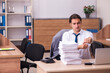 © Elnur - Young male employee unhappy with excessive work in the office