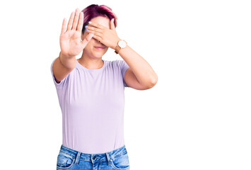 Sticker - Young beautiful woman with pink hair wearing casual clothes covering eyes with hands and doing stop gesture with sad and fear expression. embarrassed and negative concept.