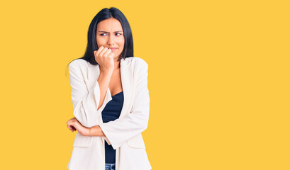 Sticker - Young beautiful latin girl wearing business clothes looking stressed and nervous with hands on mouth biting nails. anxiety problem.