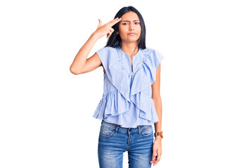 Sticker - Young beautiful latin girl wearing casual clothes shooting and killing oneself pointing hand and fingers to head like gun, suicide gesture.