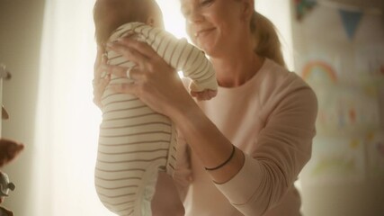 authentic footage of a cute newborn baby lying on the back in child crib in cozy warm bright room