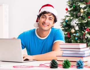 Young student with book at Christmas eve