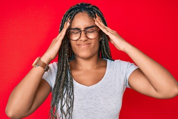 Poster - Young african american woman with braids wearing casual clothes and glasses with hand on head, headache because stress. suffering migraine.