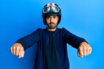 Sticker - Young hispanic man holding motorcycle helmet skeptic and nervous, frowning upset because of problem. negative person.