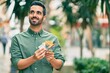 © Krakenimages.com - Young hispanic man smiling happy counting australian dollars at the city.