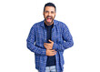© Krakenimages.com - Young hispanic man wearing casual clothes smiling and laughing hard out loud because funny crazy joke with hands on body.