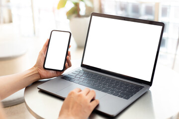 computer screen,cell phone blank mockup.hand woman work using laptop texting mobile. with white back