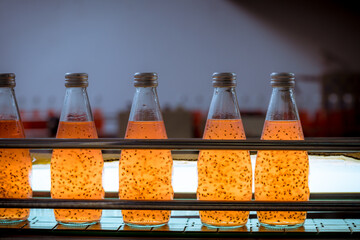 bottles from basil seed beverage factory conveyor belt with bottles for juice or water to distributi