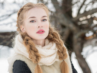 Beautiful Russian woman in a traditional dress. Russian village. Winter.