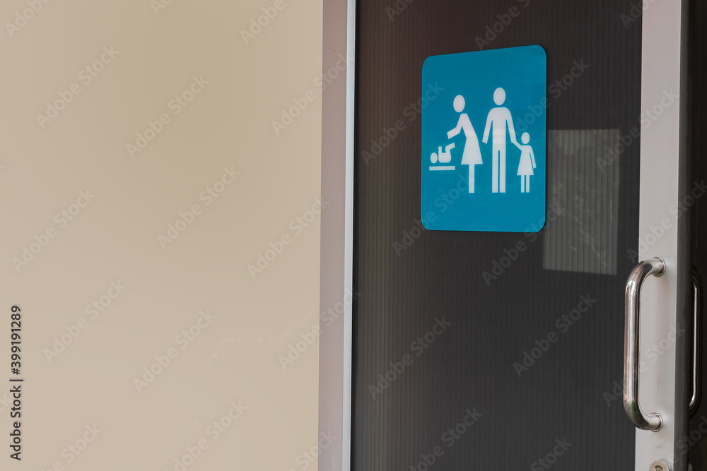 Image of family restroom sign shown on slide door of public toilet with ...