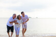 © sutthichai - Happy family walking relax on the beach.