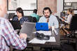 © JackF - Latin hipster guy attentively watching webinar online using headset in modern coworking space
