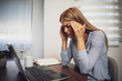 © djoronimo - Young  woman is working from home. She is having headache.