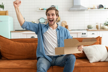 Happy man customer unpacking cardboard box receive open post mail delivery package