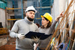 © JackF - Female architect and young contractor discussing construction plan at building site