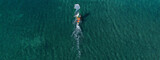 Fototapeta Nowy Jork - Aerial drone ultra wide top view photo of fit man practising wind surfing in Mediterranean bay with crystal clear emerald sea