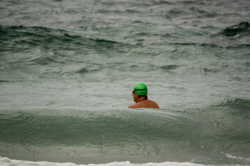 Wall Mural - Early morning swimmers heading out at the famous Coogee Beach for an early morning swim