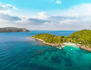 Aerial view of beautiful landscape, tourism boats, and people swimming on the sea and beach on May Rut island (a tranquil island with beautiful beach) in Phu Quoc, Kien Giang, Vietnam.