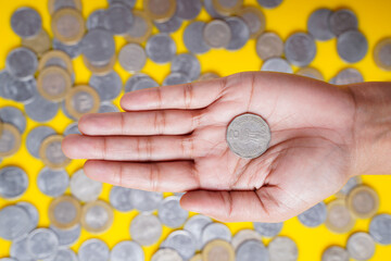 Indian rupees coin holding in women hand