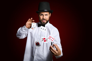 Sticker - male magician showing tricks with cards on dark background