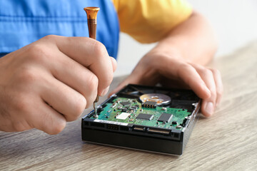 Technician repairing computer in service center, closeup