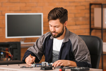 Technician repairing computer in service center