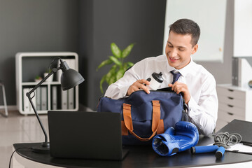 Wall Mural - Young businessman going to go to boxing training after working day in office