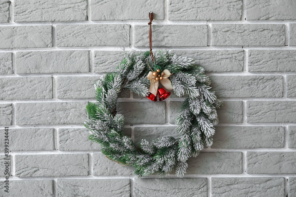Beautiful Christmas wreath hanging on brick wall
