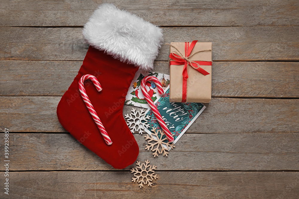 Composition with Christmas sock on wooden background