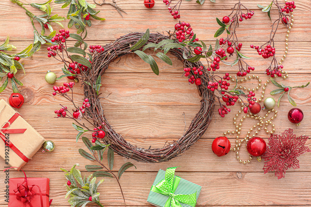 Beautiful Christmas wreath and decor on wooden table