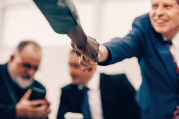 Poster - successful business people shaking hands at an office meeting