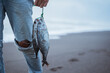 © Odua Images - Close up fisherman getting fish from his fishing
