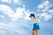 Golfer sport course golf ball fairway. People lifestyle woman playing game golf tee of blue sky background. Asia female player game shot in summer. 