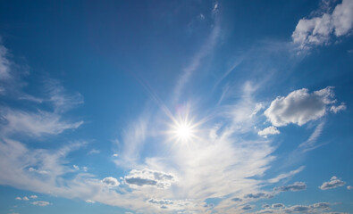 Wall Mural - blue sky with clouds and bright sun