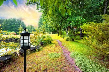 Wall Mural - path past lake in park with lantern