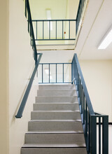 Stairwell With A Metal Handrail.