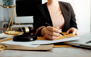 Business and lawyers discussing contract papers with brass scale on desk in office. Law, legal services, advice, justice and law concept picture with film grain effect