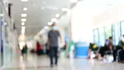 Wall Mural - blurred hospital background video from perspective building hallway for useus way to medicine or hospital motion background