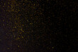 Leinwandbild Motiv Golden falling glitter on the black background, festive overlay