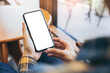 © panitan - cell phone blank white screen mockup.woman hand holding texting using mobile on desk at office.background empty space for advertise.work people contact marketing business,technology