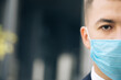 Pandemic protection of the Covid-19 coronavirus. Caucasian man in a medical face mask. Virus protection. Half face in frame with copy space. The concept health and safety.