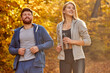 couple run together in the autumn forest, athletic sportive man and woman in sportswear enjoy jogging on fresh air, at sunny day