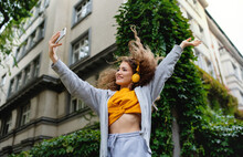 Young Woman With Smartphone Dancing Outdoors On Street, Tik Tok Concept.