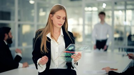 Attractive blonde businesswoman holding futuristic gadget. GUI (Graphical User Interface). cheerful young woman uses a holographic tablet