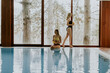 © BGStock72 - Beautiful young women relaxing by the indoor swimming pool