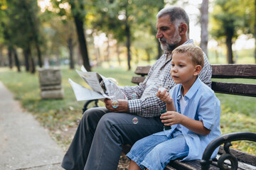 Wall Mural - boy with his grandfather in public park