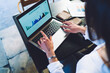 © BullRun - Selective focus on laptop screen with displayed business infographics for analyzing, female student e learning for editing statistics diagrams and finish web course work of financial knowledge